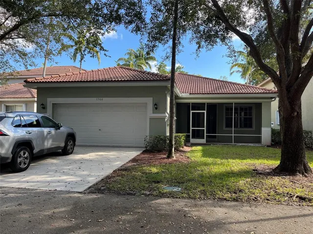 a kitchen with stainless steel appliances granite countertop a sink a stove and cabinets