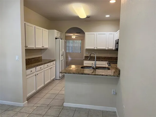 a kitchen with stainless steel appliances a sink a stove a microwave and cabinets