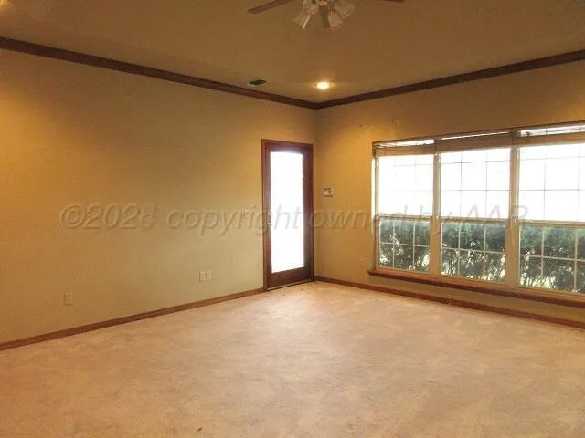 an empty room with large windows