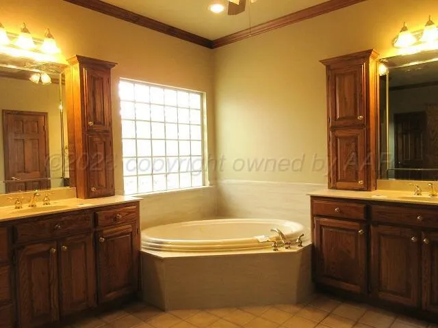 a bathroom with a tub sink and mirror