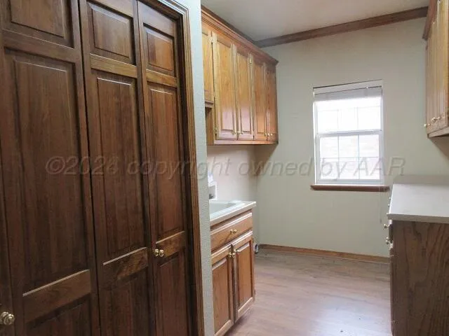 a view of a kitchen with an empty space and a window