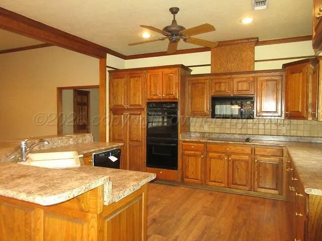 a kitchen with stainless steel appliances granite countertop a sink and cabinets