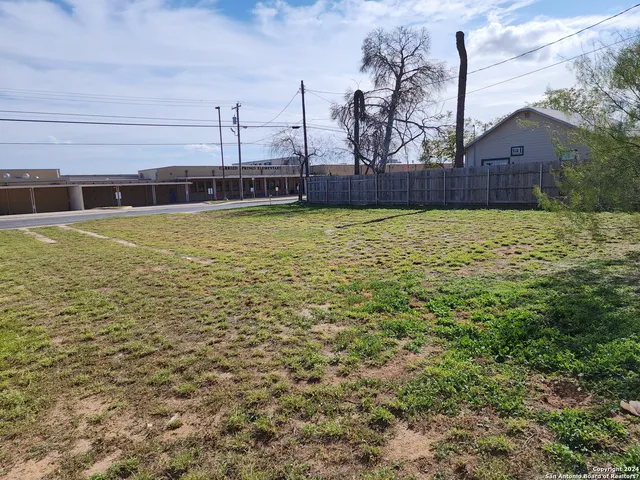 a view of a swimming pool with a yard