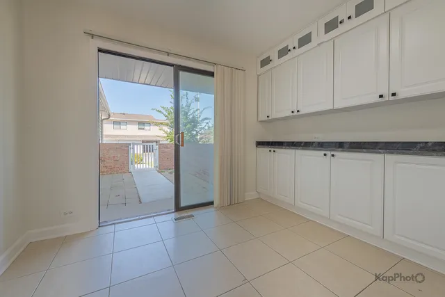 a view of a kitchen with white cabinets