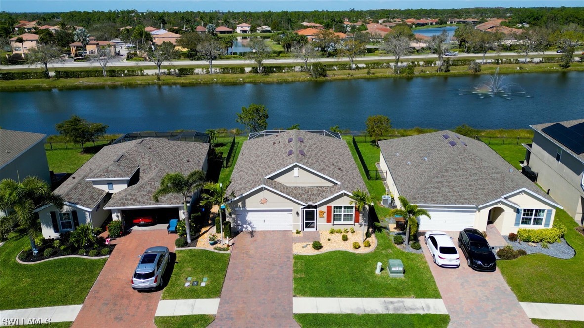 an aerial view of multiple houses with a lake view