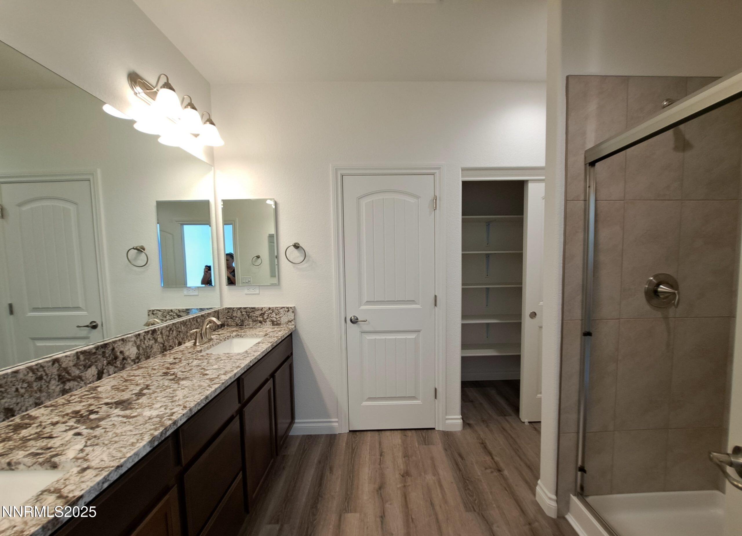 4048 Cold Springs Reno, NV 89508 - Photo 7 of 8 a bathroom with a granite countertop sink a mirror and shower