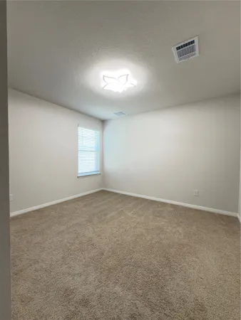 an empty room with a empty space and windows