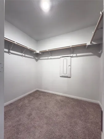 an empty room with a window and a fireplace