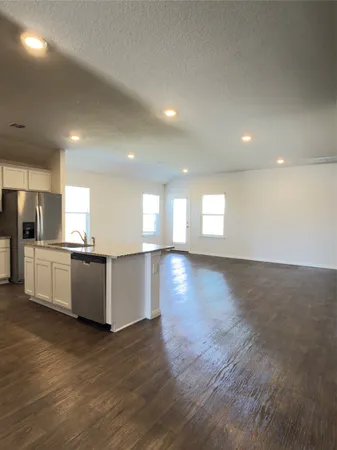 a view of a kitchen with a sink and a refrigerator