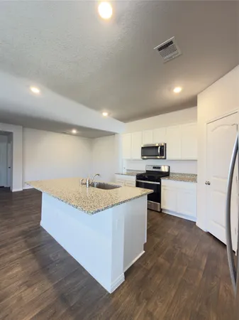 a kitchen with stainless steel appliances granite countertop a stove and a sink