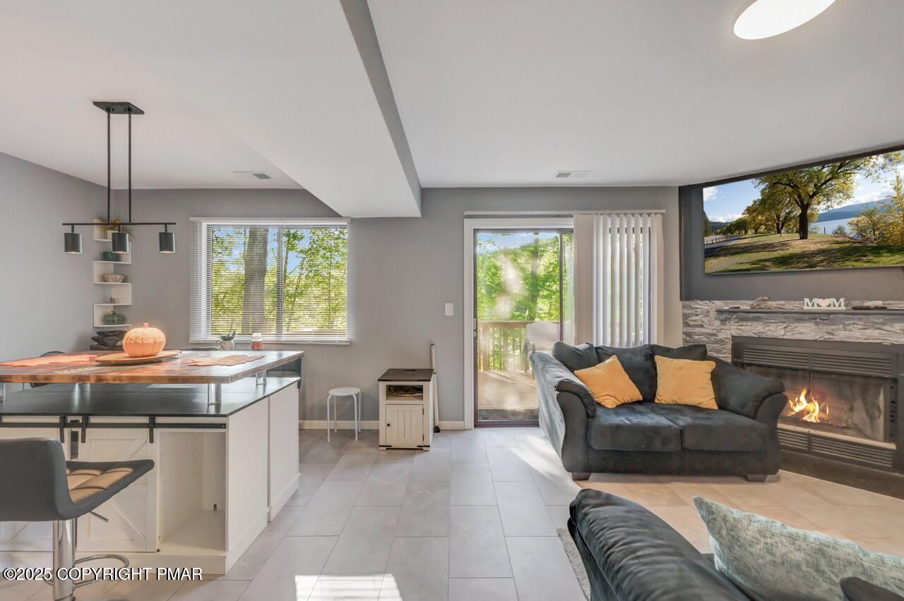 3305 Windemere Drive Bushkill, PA 18324 - Photo 13 of 56 a living room with furniture and a fireplace