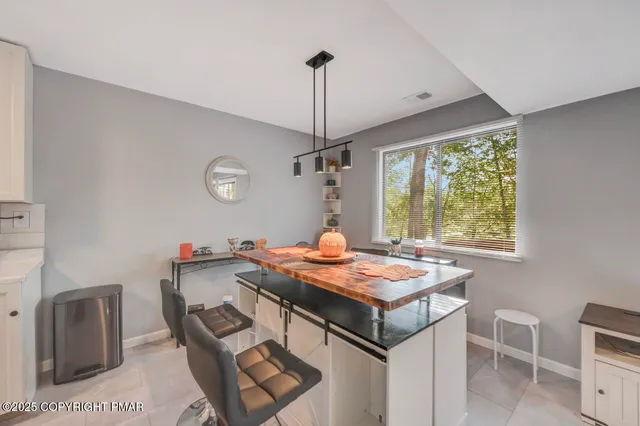 a kitchen that has a table and chairs in it