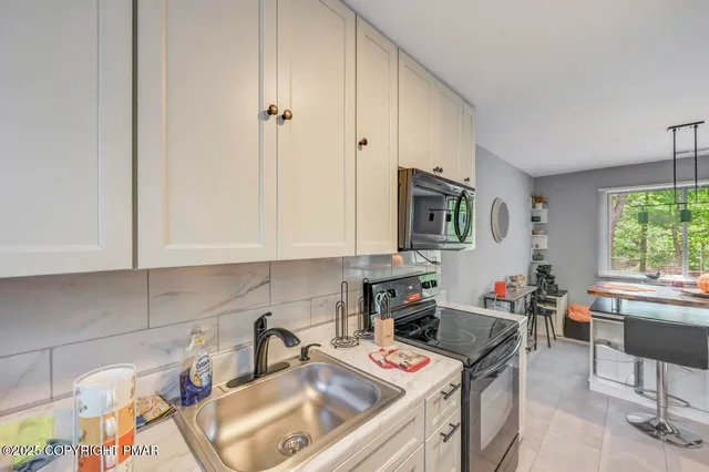 a kitchen with stainless steel appliances granite countertop a refrigerator sink and wooden floor
