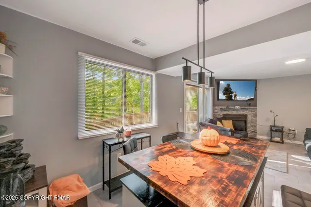 a room with stainless steel appliances furniture a chandelier and a rug