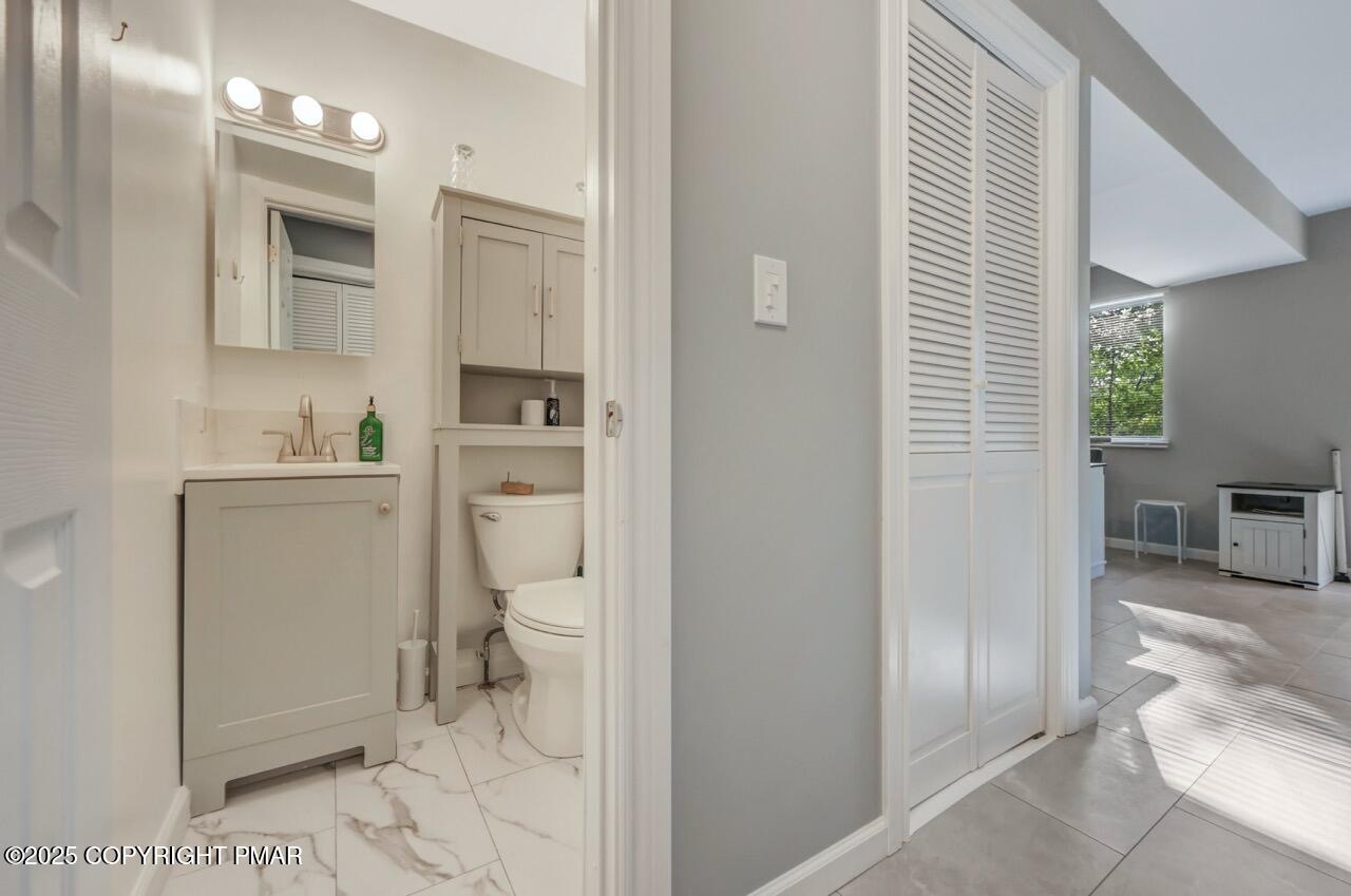 3305 Windemere Drive Bushkill, PA 18324 - Photo 23 of 56 a bathroom with a sink a toilet and shower