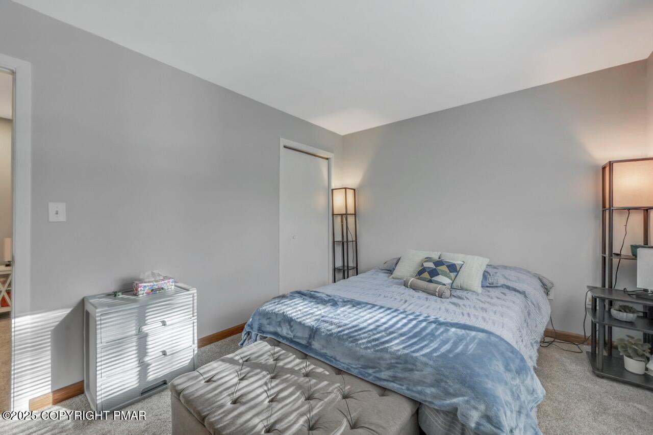 3305 Windemere Drive Bushkill, PA 18324 - Photo 31 of 56 a bedroom with a bed and wooden floor