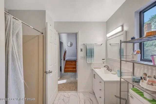 a view of a room that has a bed in it