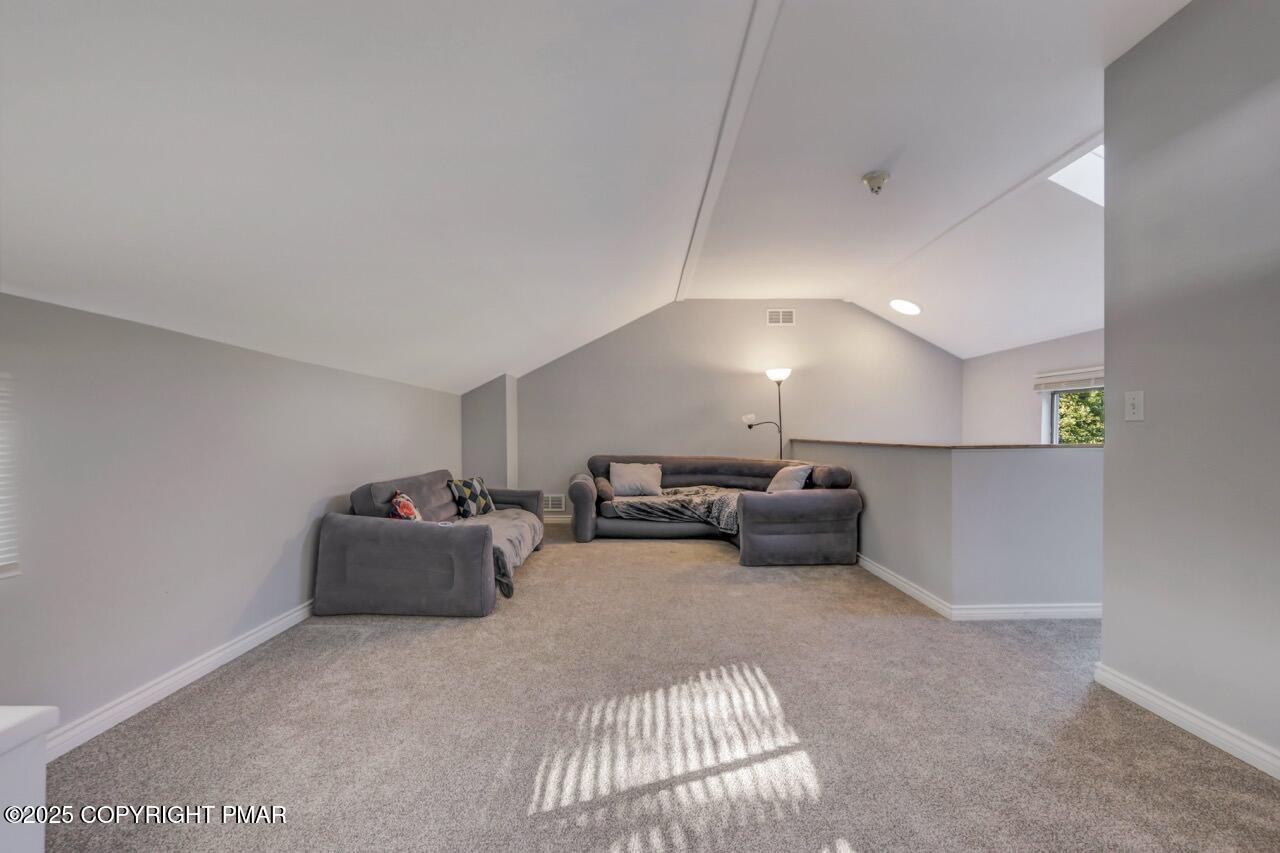 3305 Windemere Drive Bushkill, PA 18324 - Photo 43 of 56 a living room with furniture and a chandelier