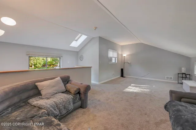 a balcony with wooden floor and outdoor seating
