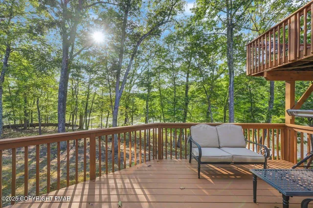 a view of balcony with wooden floor and outdoor seating