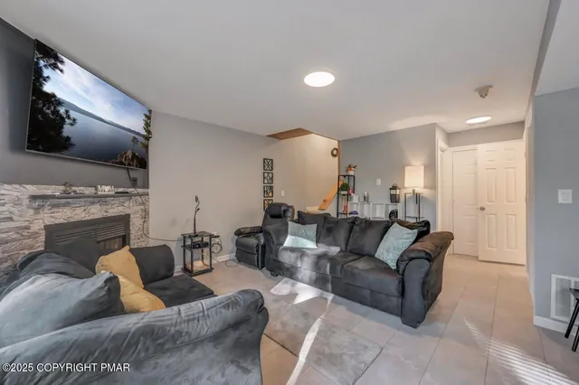 a living room with furniture and a fireplace