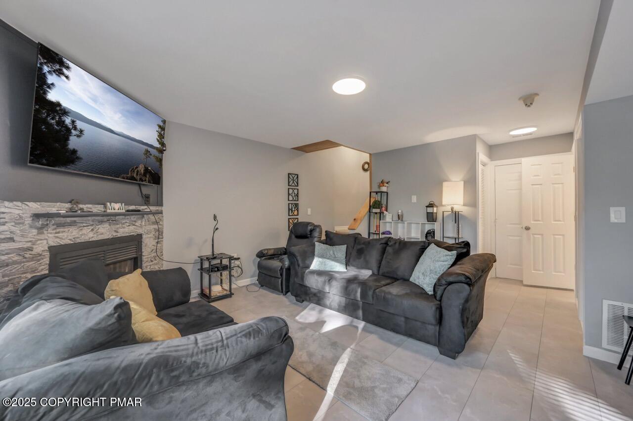 3305 Windemere Drive Bushkill, PA 18324 - Photo 9 of 56 a living room with furniture and a fireplace