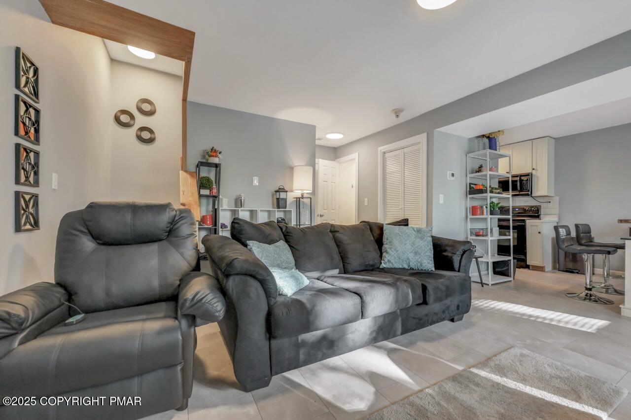 3305 Windemere Drive Bushkill, PA 18324 - Photo 10 of 56 a living room with furniture and a wooden floor