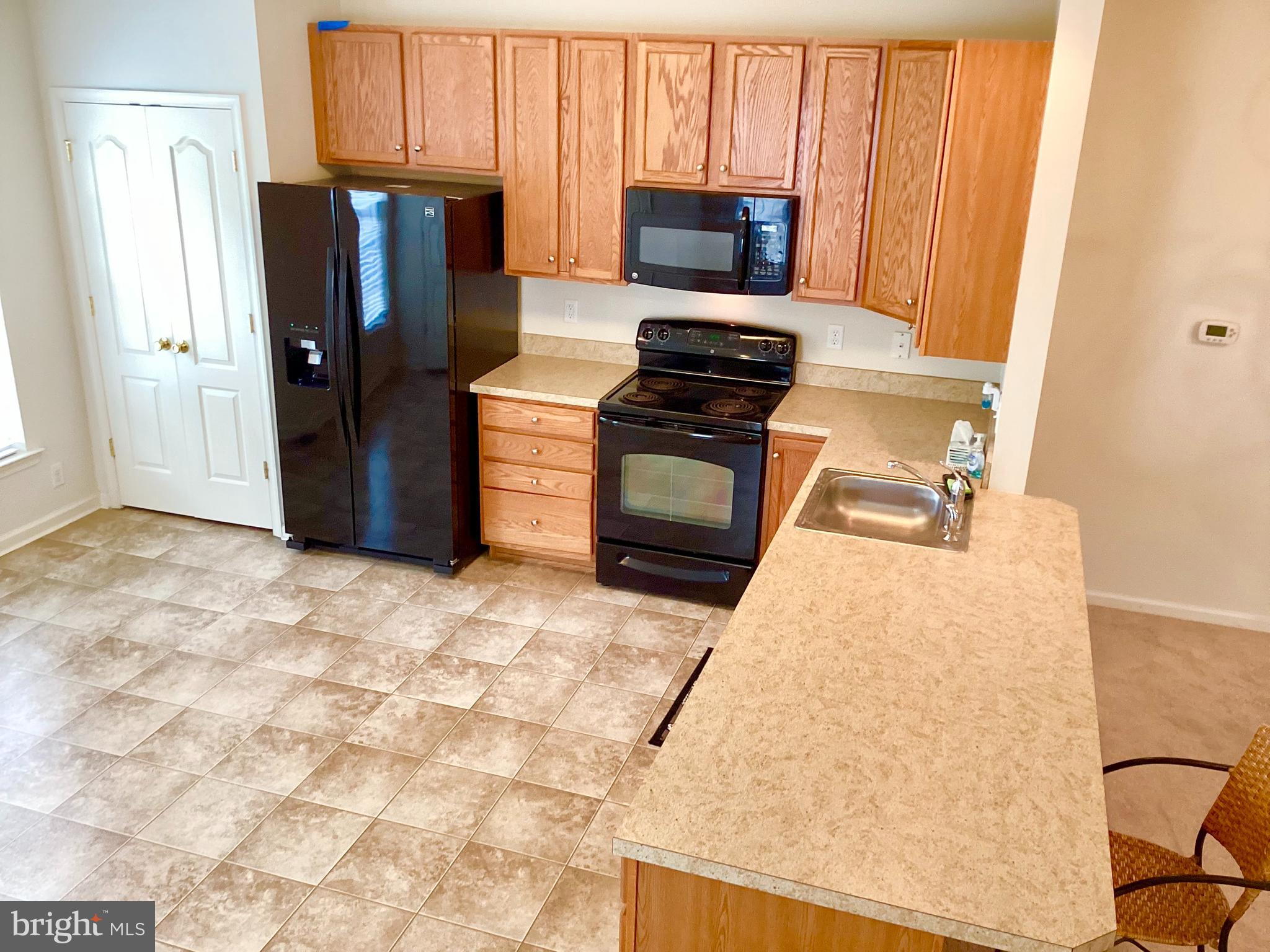 140 Pumpkin Patch Lane Hockessin, DE 19707 - Photo 12 of 25 a kitchen with stainless steel appliances granite countertop a refrigerator stove and microwave