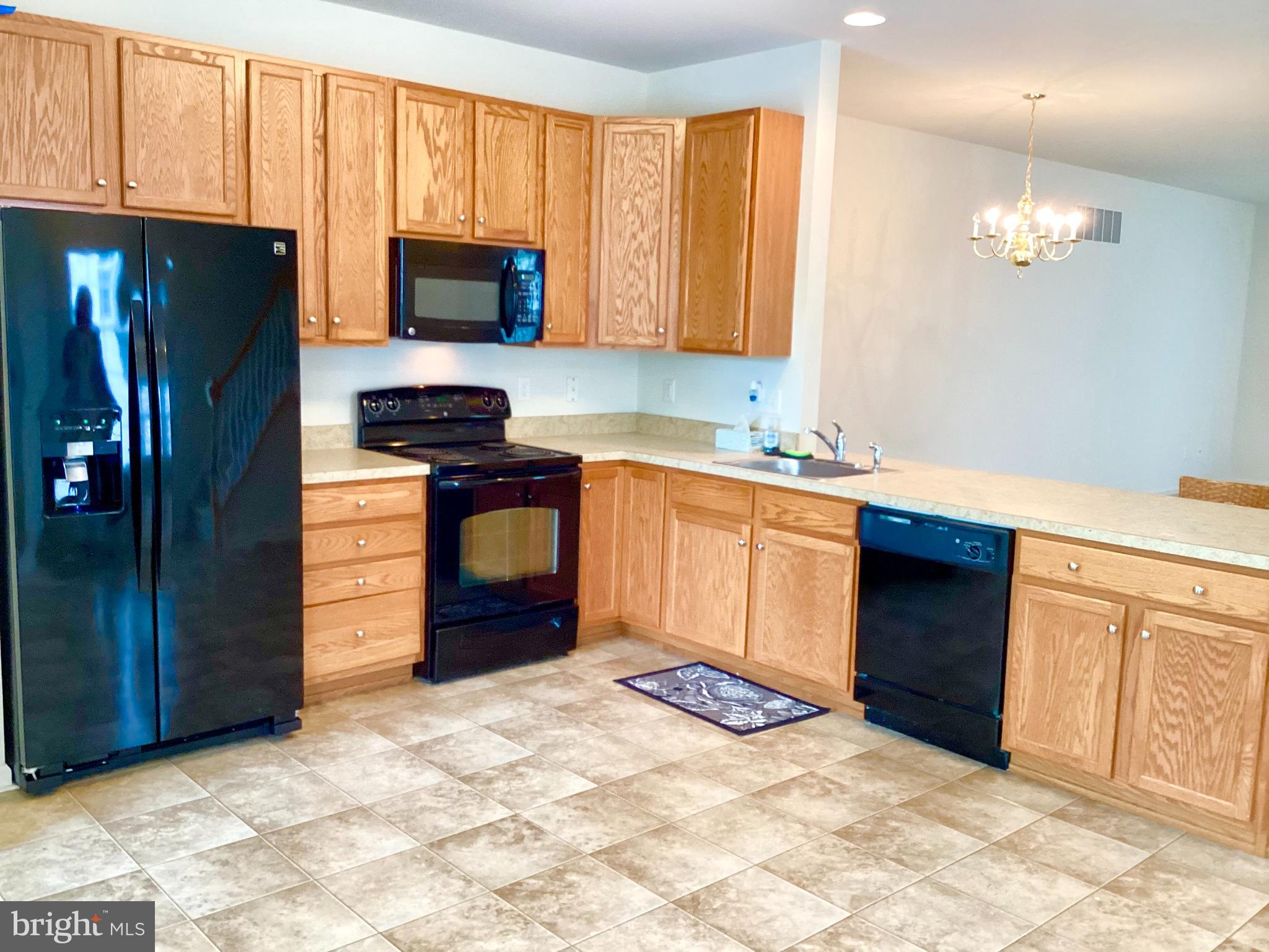 140 Pumpkin Patch Lane Hockessin, DE 19707 - Photo 10 of 25 a kitchen with stainless steel appliances granite countertop a stove a sink and a refrigerator