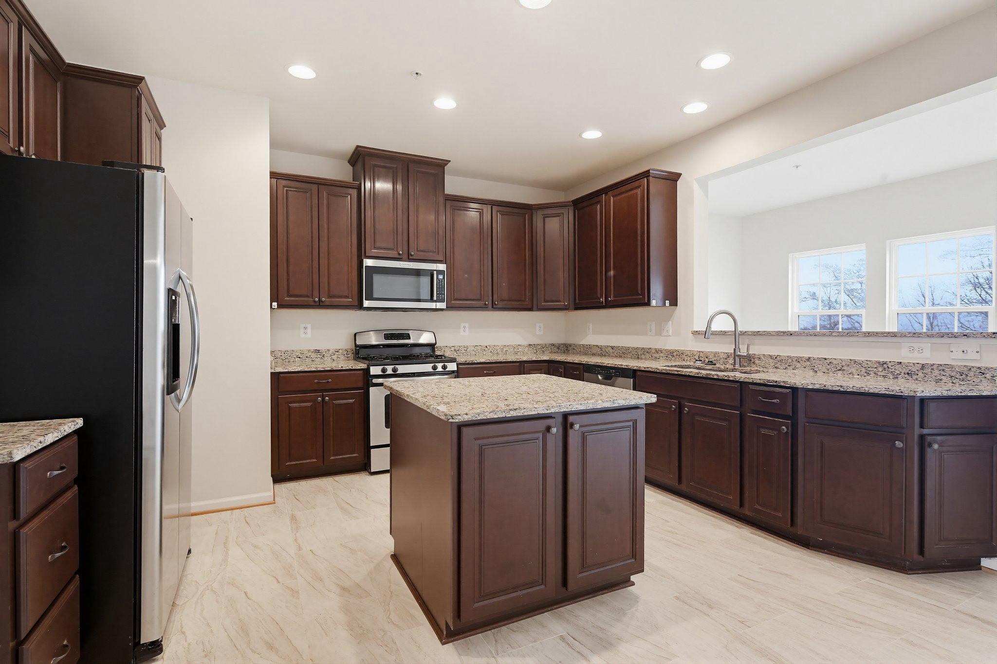 3819 Cullingworth Road Burtonsville, MD 20866 - Photo 12 of 50 a kitchen with stainless steel appliances granite countertop a refrigerator stove a sink and dishwasher