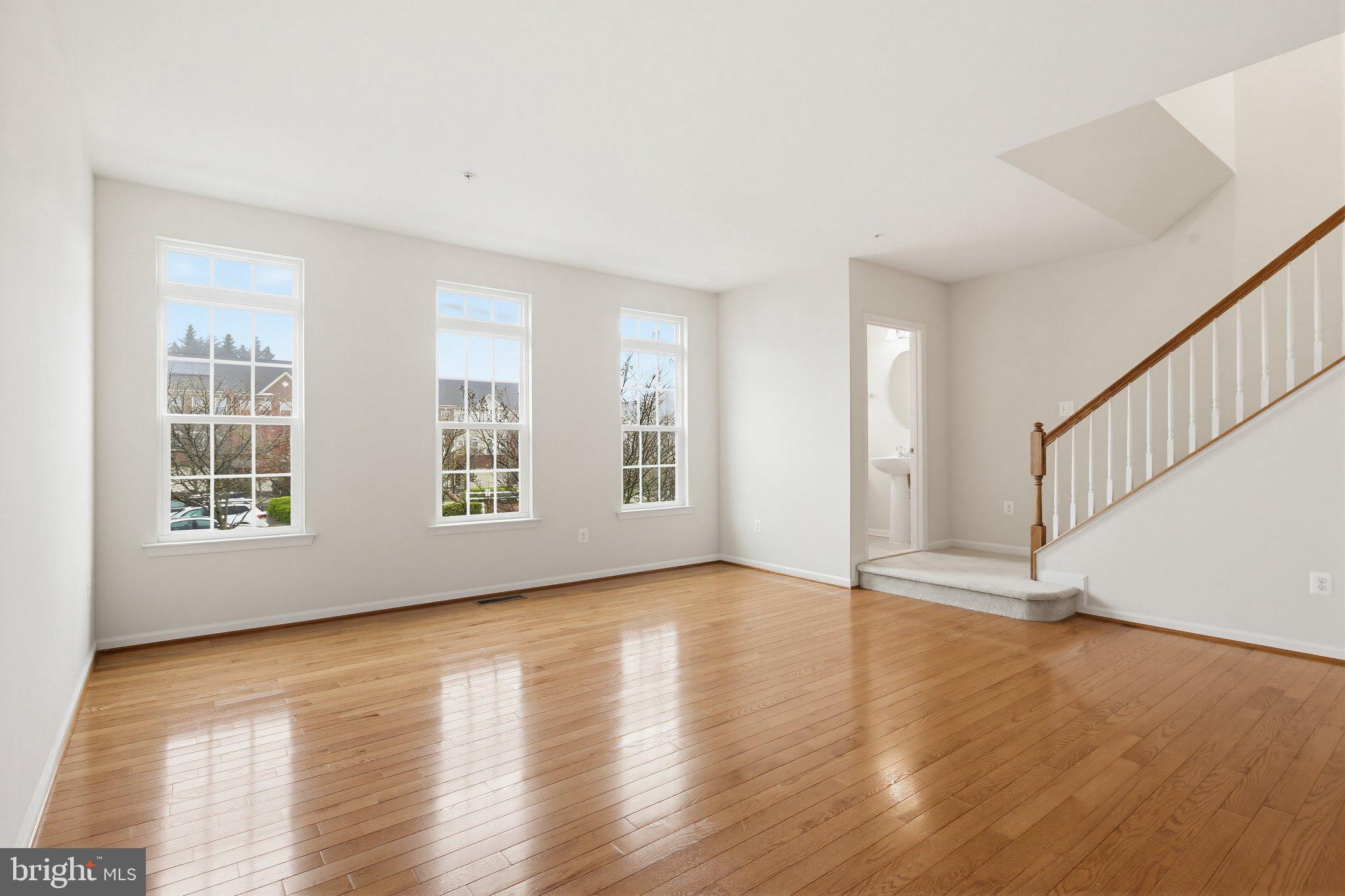 3819 Cullingworth Road Burtonsville, MD 20866 - Photo 2 of 50 a view of an empty room with wooden floor and windows