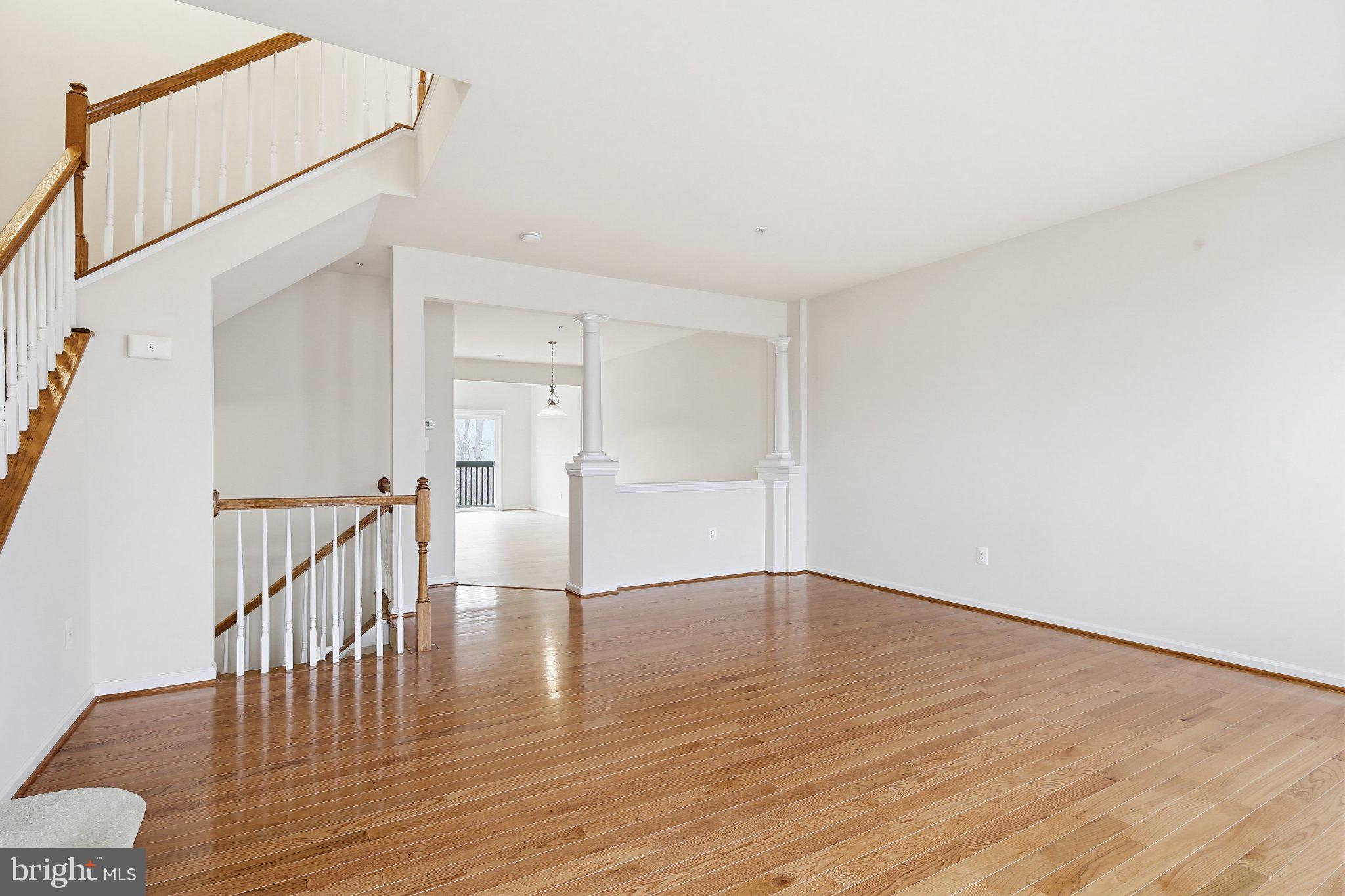 3819 Cullingworth Road Burtonsville, MD 20866 - Photo 4 of 50 a view of an empty room with wooden floor and a window