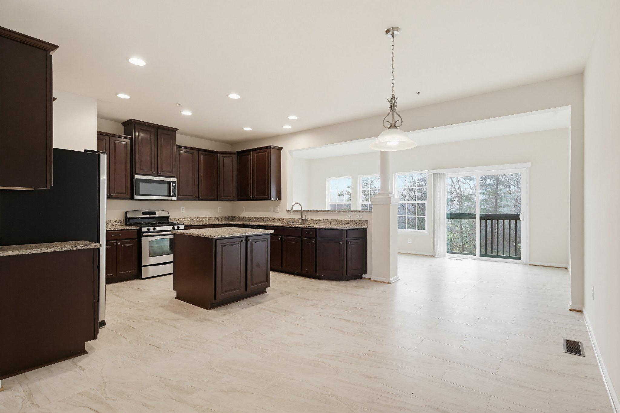 3819 Cullingworth Road Burtonsville, MD 20866 - Photo 7 of 50 a large kitchen with stainless steel appliances granite countertop a stove a sink dishwasher a refrigerator and a oven with wooden floor