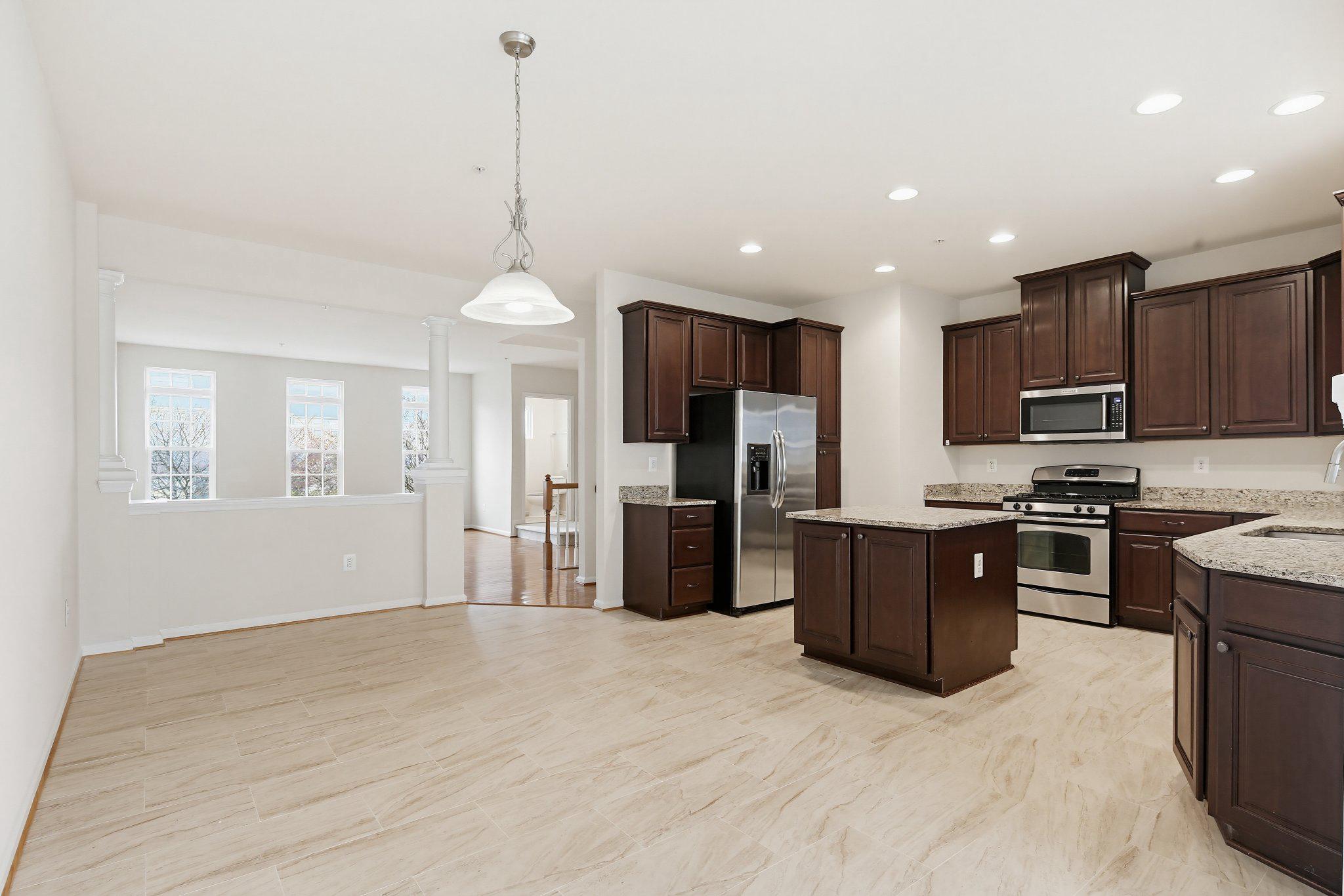 3819 Cullingworth Road Burtonsville, MD 20866 - Photo 9 of 50 a kitchen with stainless steel appliances granite countertop a refrigerator a sink a stove top oven and a center island