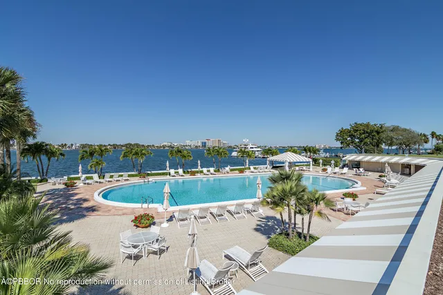 a view of a swimming pool and outdoor seating
