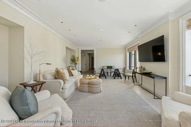a view of a livingroom with furniture and a window