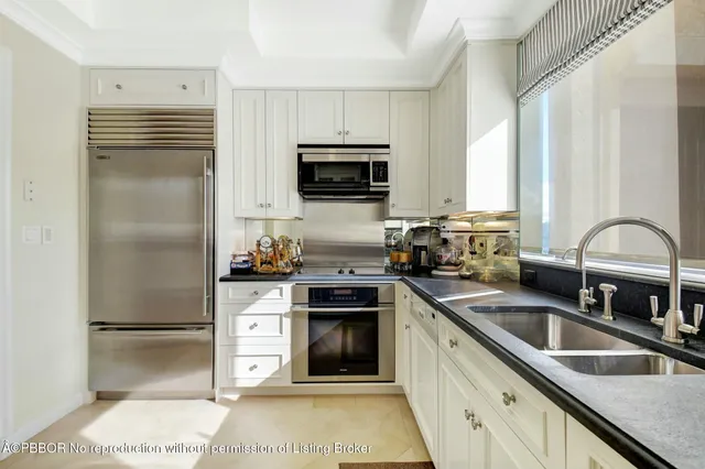 a kitchen with a sink and white cabinets
