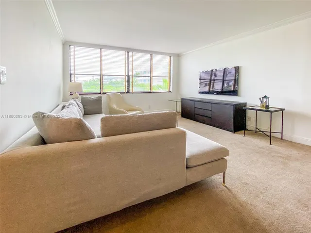 a spacious bedroom with a bed and a window