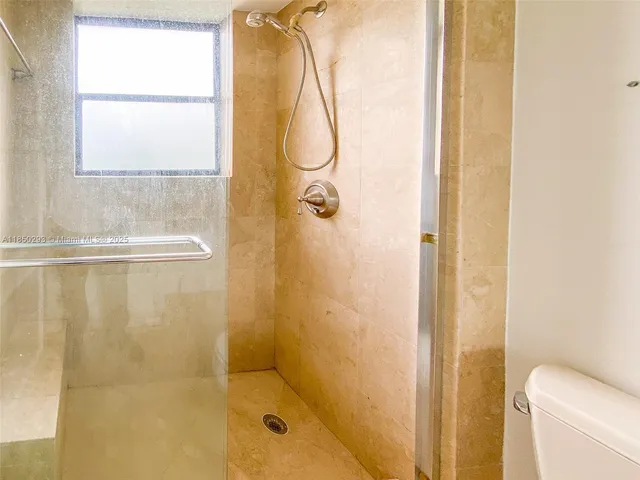 a bathroom with a shower sink and mirror