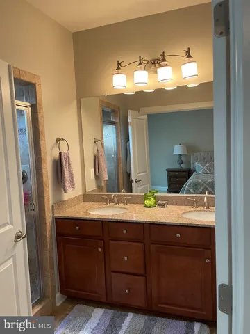 a bathroom with a double vanity sink and a mirror