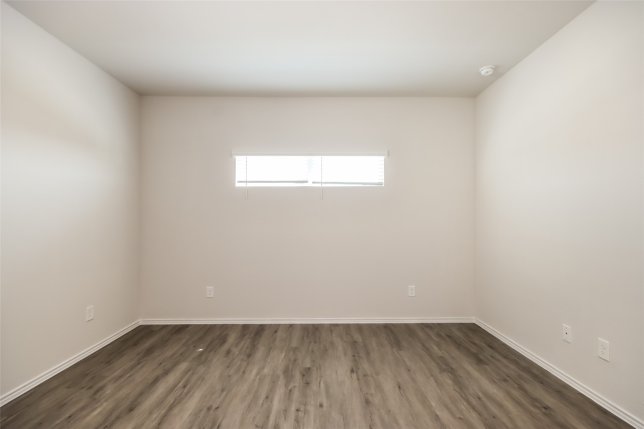 15226 Estrella Road West Houston, TX 77073 - Photo 12 of 13 a view of an empty room with wooden floor and a window