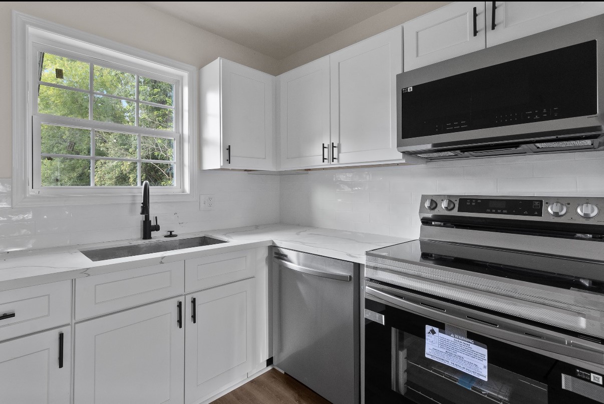 5031 Mallow Street Houston, TX 77033 - Photo 3 of 11 a kitchen with a sink and a stove top oven