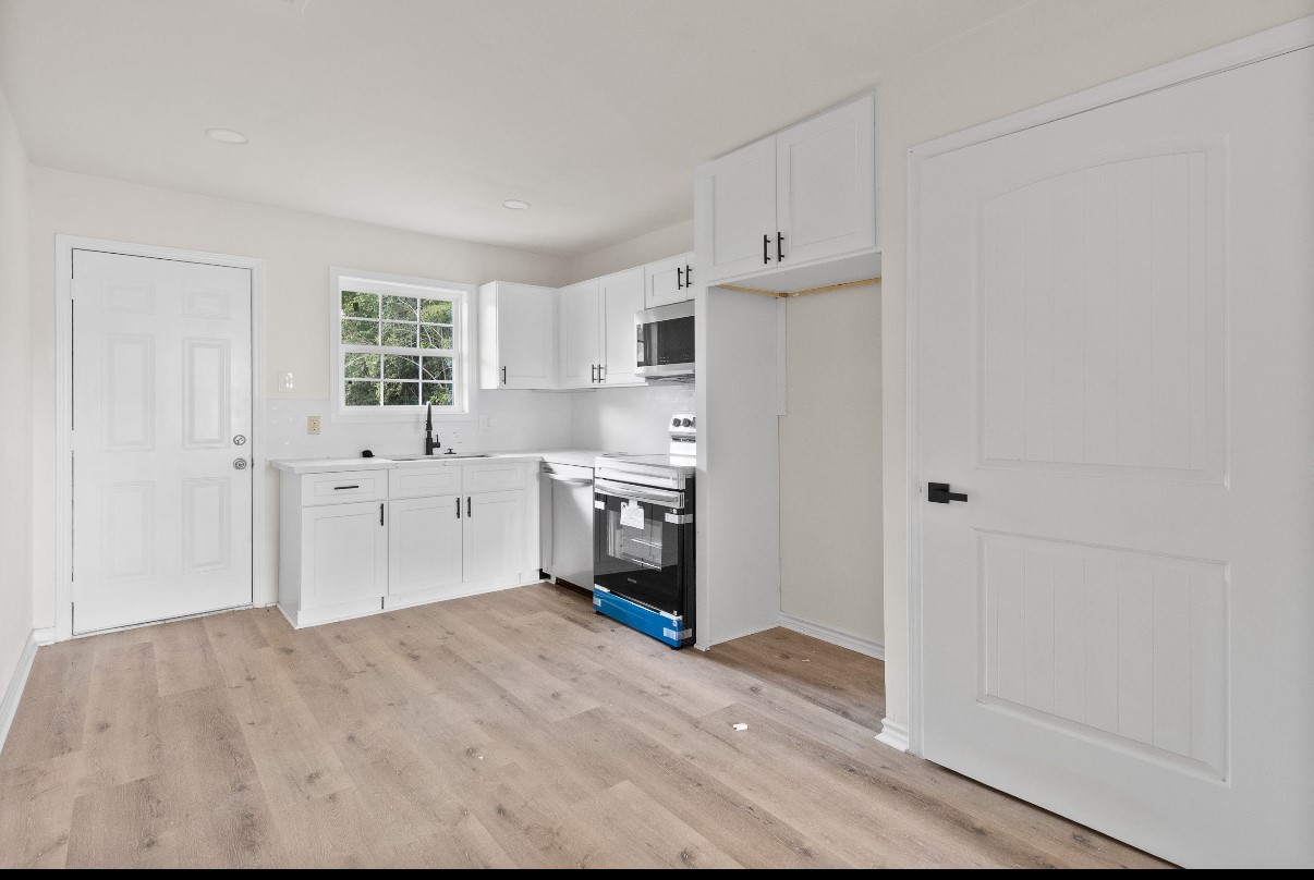 5031 Mallow Street Houston, TX 77033 - Photo 6 of 11 a view of a kitchen with white cabinets