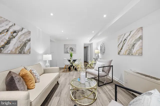 a living room with furniture and wooden floor