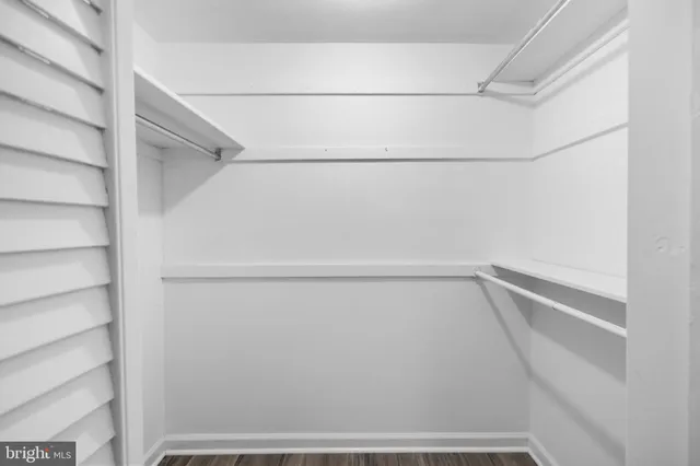 a view of walk in closet with empty racks