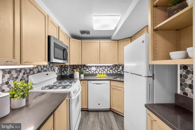 a kitchen with a sink stove and refrigerator