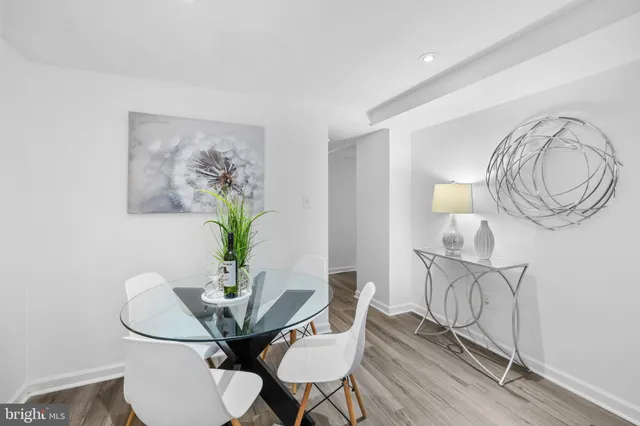 a view of a dining room with furniture wooden floor and a chandelier