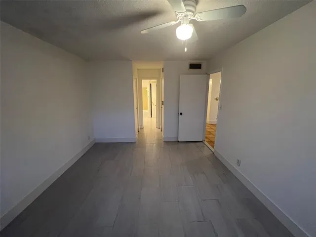 a view of a livingroom with a ceiling fan and window