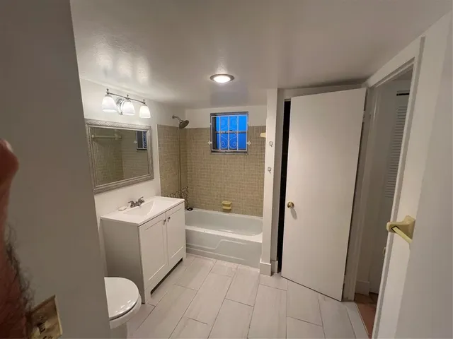 a bathroom with a sink a toilet and mirror