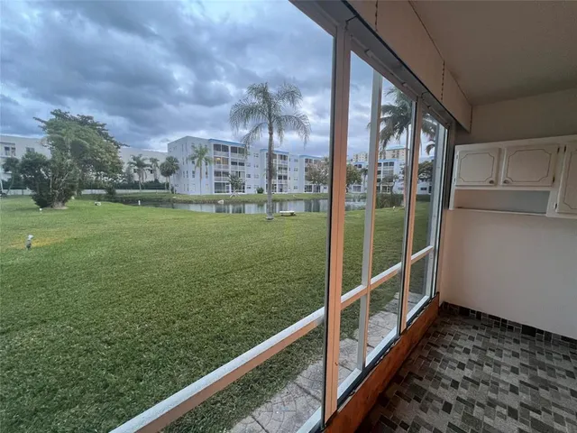 a view of a balcony with yard